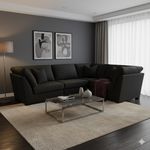 Modern living room with a dark gray sectional sofa, glass coffee table, and abstract art on the wall.