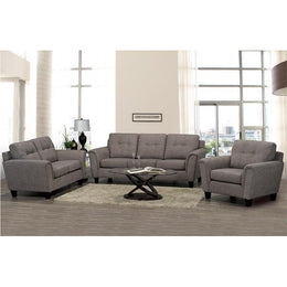 Gray sofa set in a living room with a coffee table and decor items.
