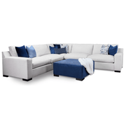 White sectional sofa with blue and patterned cushions on a white background